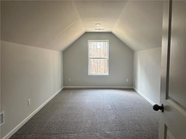 additional living space with lofted ceiling, carpet, visible vents, and baseboards