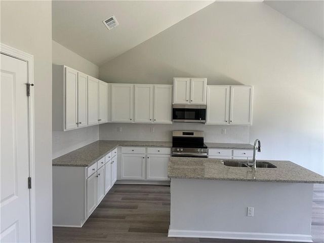 kitchen featuring stainless steel appliances, dark wood-type flooring, white cabinets, a sink, and light stone countertops