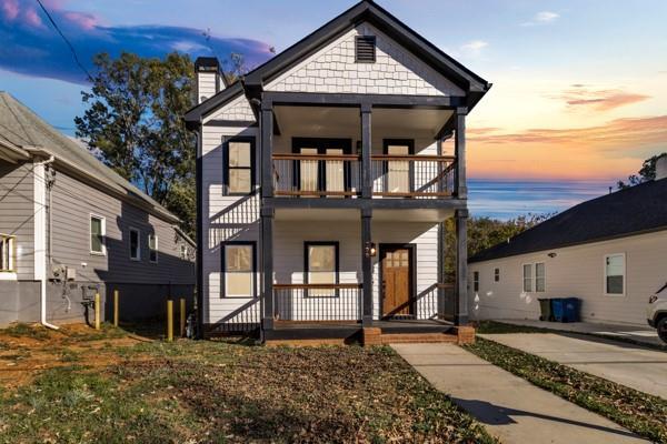 view of front of home with covered porch and a balcony