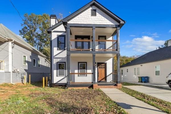 view of front of property featuring covered porch and a balcony