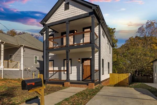 view of front of house featuring covered porch and a balcony