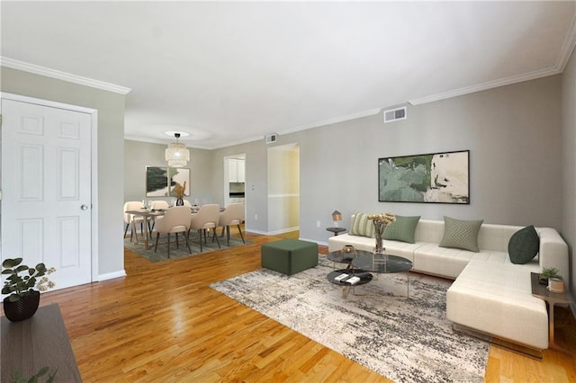 living room featuring ornamental molding and hardwood / wood-style flooring