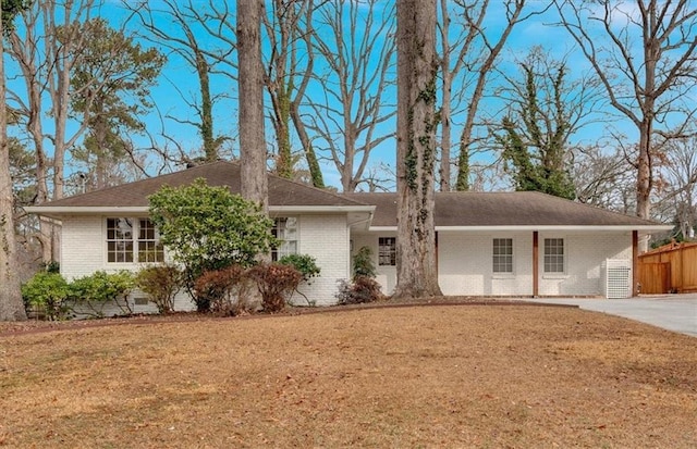 single story home with a carport and a front yard