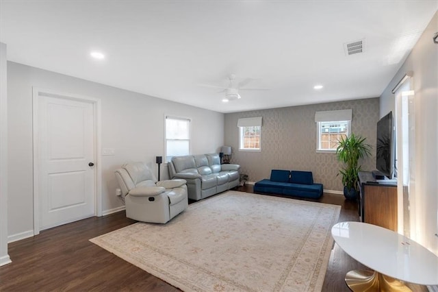 living room with dark wood-type flooring and ceiling fan