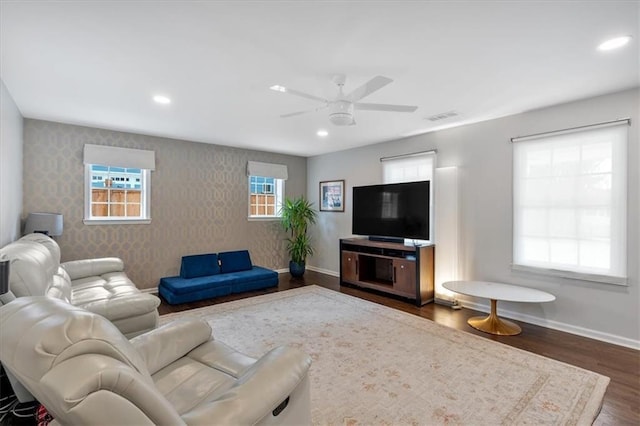 living room with dark wood-type flooring and ceiling fan