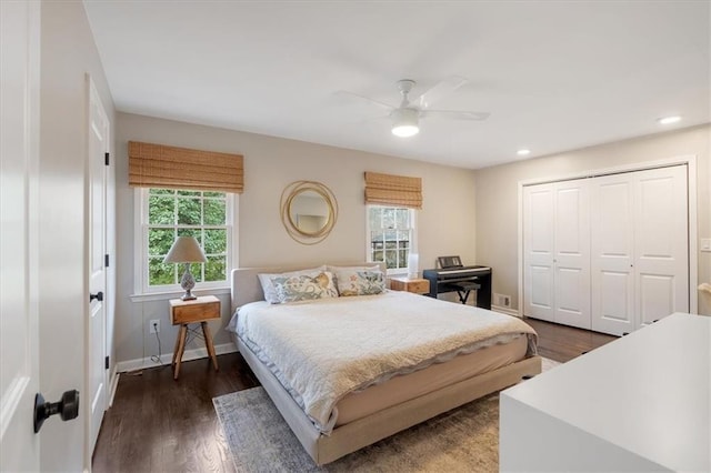 bedroom with ceiling fan, dark hardwood / wood-style flooring, and a closet