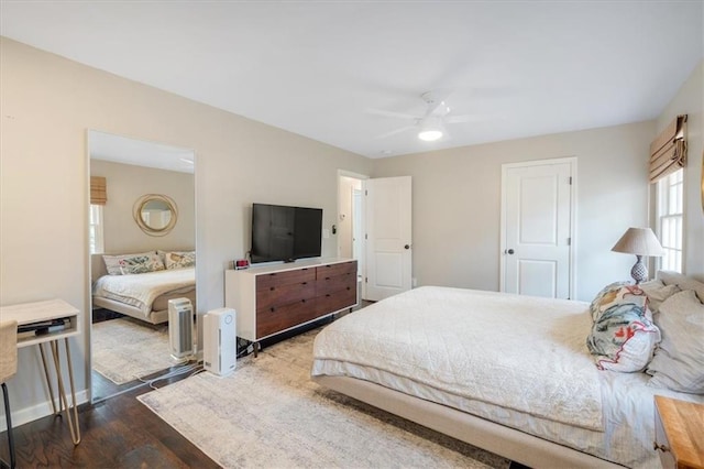 bedroom with dark wood-type flooring and ceiling fan