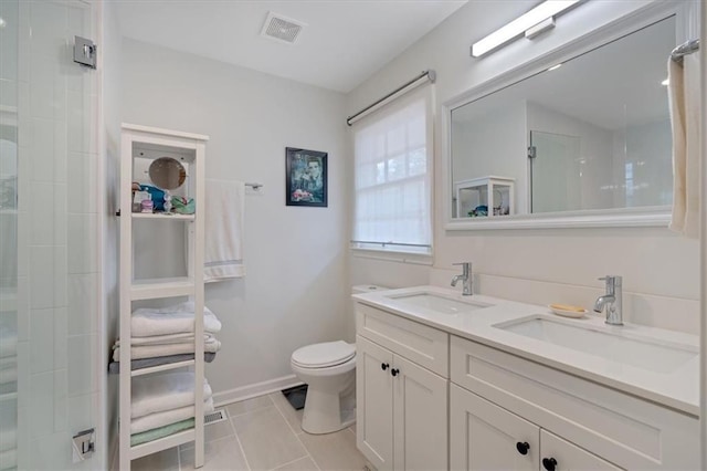 bathroom with vanity, walk in shower, tile patterned floors, and toilet