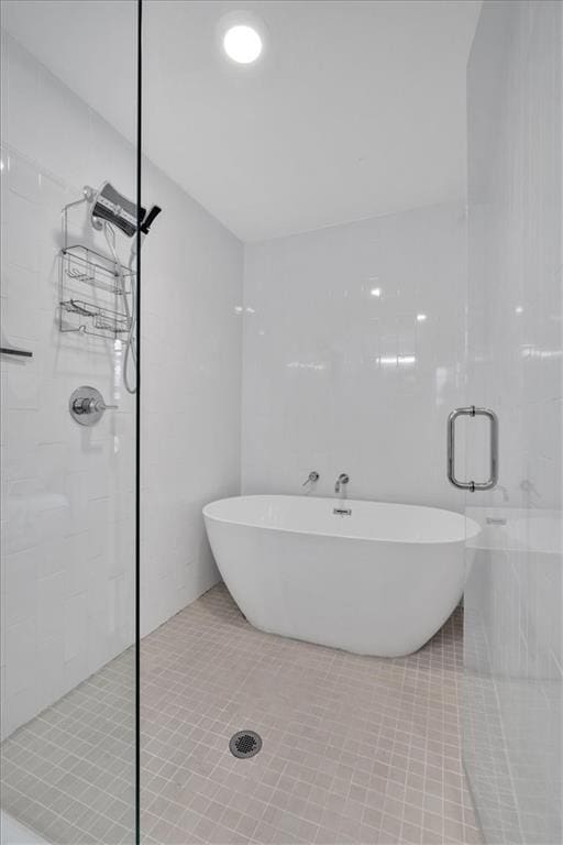 bathroom featuring tile patterned floors and shower with separate bathtub