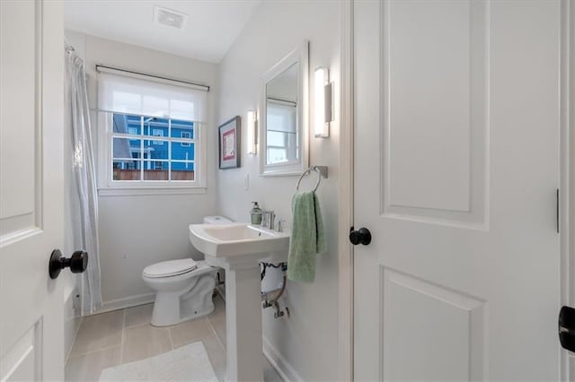 bathroom with tile patterned floors and toilet