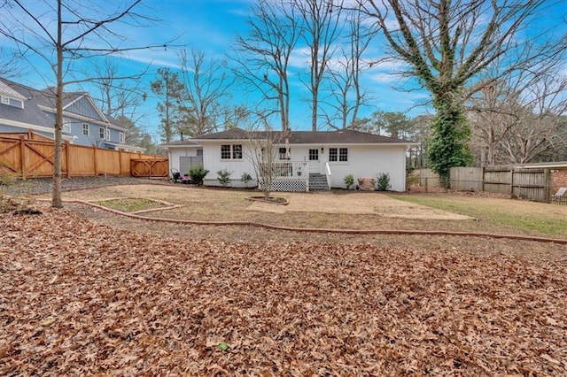 rear view of property with a yard