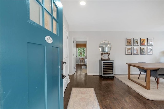 foyer with dark wood-type flooring and beverage cooler