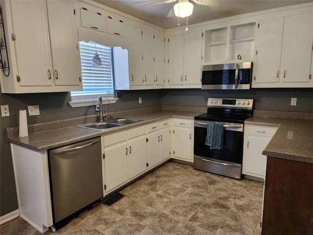 520 John Deere Rd, Monroe, GA 30656 - kitchen with stainless steel appliances, a sink, white cabinetry, a ceiling fan, and open shelves