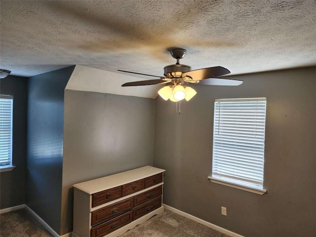 520 John Deere Rd, Monroe, GA 30656 - unfurnished room with a textured ceiling, dark carpet, baseboards, and a ceiling fan