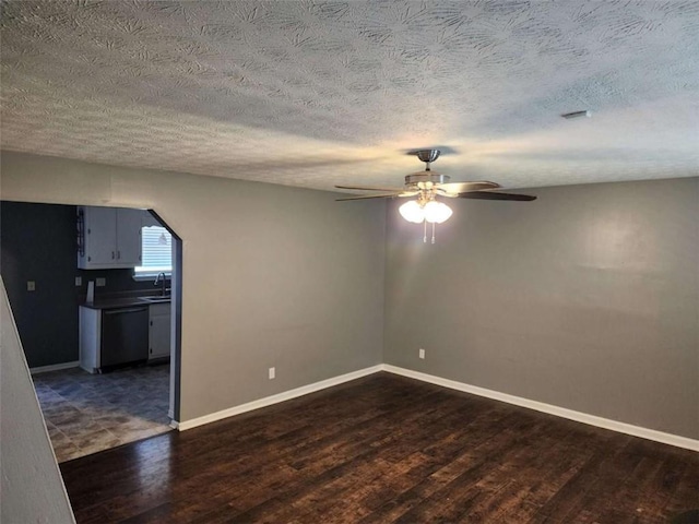 520 John Deere Rd, Monroe, GA 30656 - spare room with dark wood finished floors, a sink, ceiling fan, baseboards, and a textured ceiling
