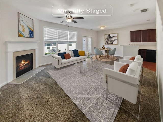 carpeted living room featuring ceiling fan