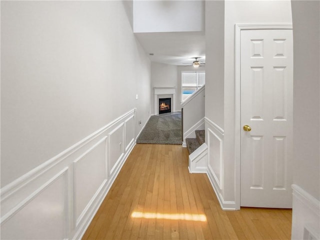 corridor with light hardwood / wood-style floors