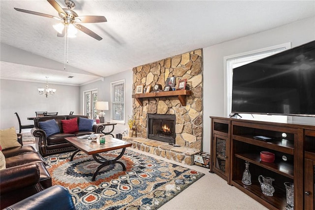 carpeted living room with a stone fireplace, lofted ceiling, ceiling fan with notable chandelier, and a textured ceiling