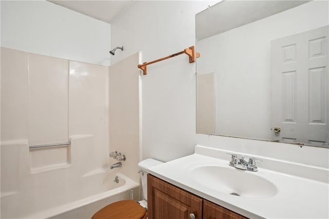 bathroom featuring toilet, vanity, and shower / bathing tub combination