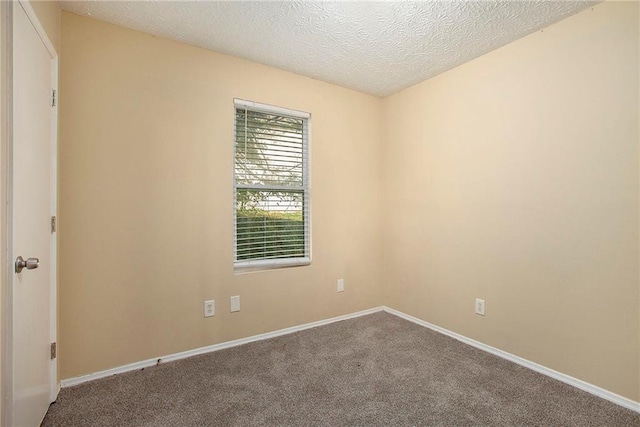 carpeted spare room with a textured ceiling