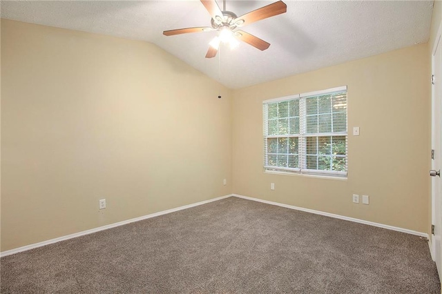 empty room featuring a textured ceiling, ceiling fan, carpet, and vaulted ceiling