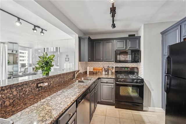 kitchen featuring dark wood-type flooring, kitchen peninsula, tasteful backsplash, and black appliances