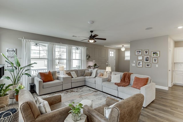 living room with ceiling fan and light hardwood / wood-style floors