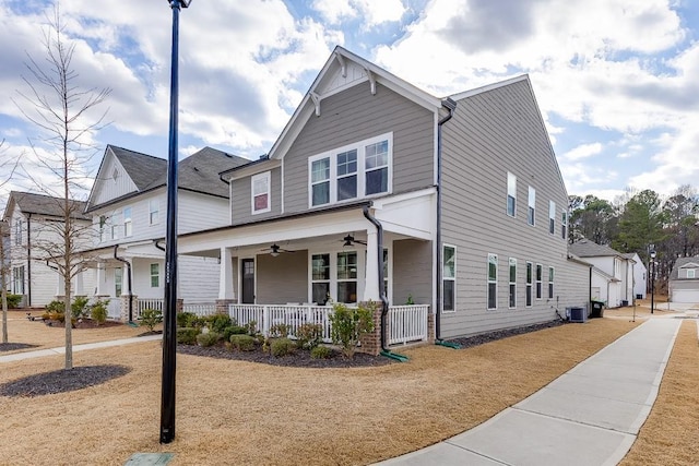 view of front of house with cooling unit, ceiling fan, and covered porch