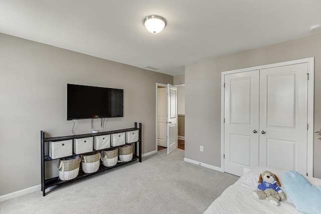 bedroom with light colored carpet and a closet