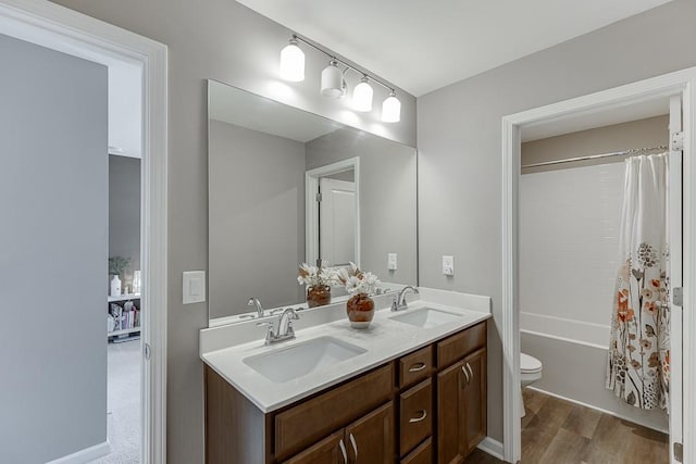 full bathroom featuring shower / tub combo, vanity, hardwood / wood-style flooring, and toilet