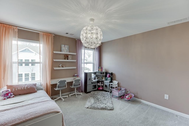 carpeted bedroom with a notable chandelier