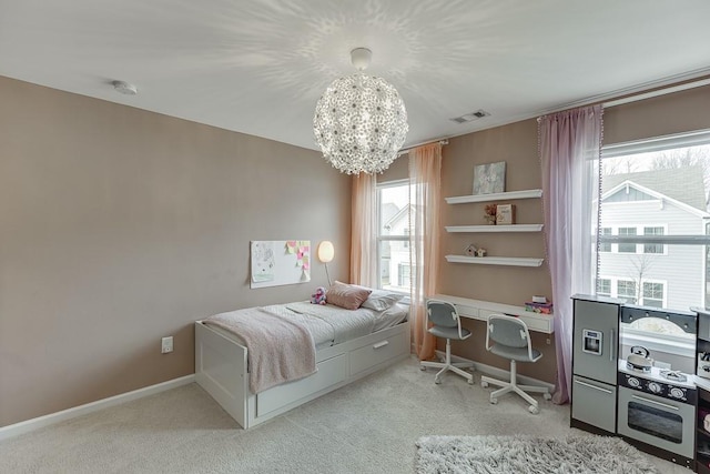 bedroom with an inviting chandelier and light colored carpet