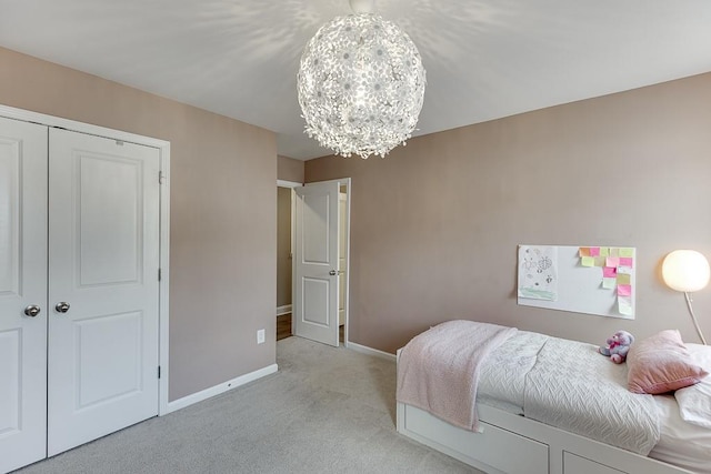 carpeted bedroom with an inviting chandelier and a closet