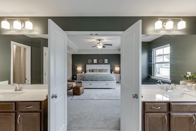 bathroom with vanity, ceiling fan, and crown molding