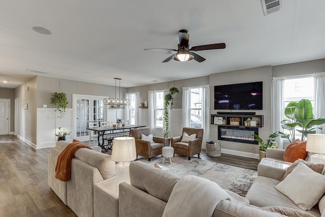 living room featuring wood-type flooring and ceiling fan