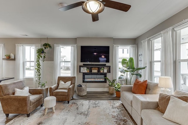 sitting room with wood-type flooring and ceiling fan