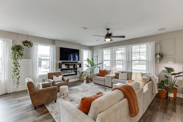 living room featuring wood-type flooring and ceiling fan