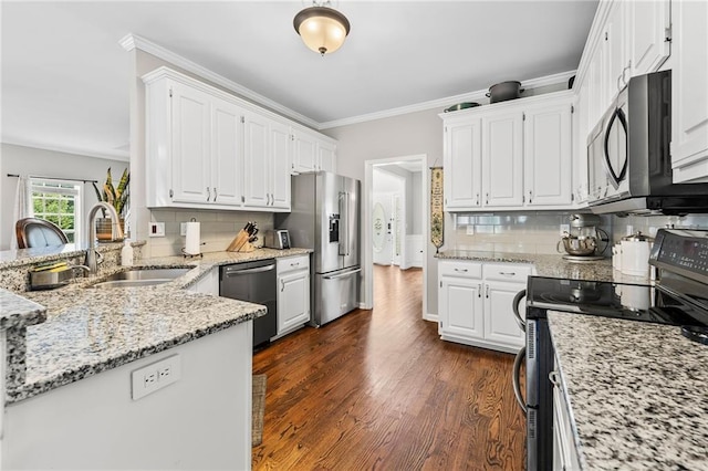 435 Ruby Forest Pkwy, Suwanee, GA 30024 - kitchen with appliances with stainless steel finishes, a sink, white cabinetry, dark wood finished floors, and ornamental molding