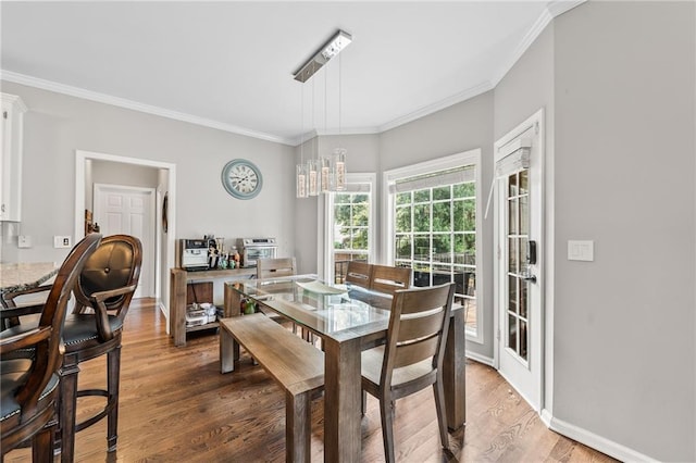 435 Ruby Forest Pkwy, Suwanee, GA 30024 - dining area with crown molding, light wood finished floors, a chandelier, and baseboards