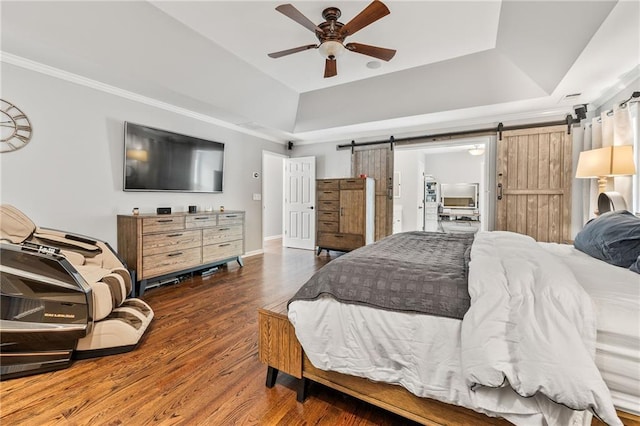 435 Ruby Forest Pkwy, Suwanee, GA 30024 - bedroom featuring a barn door, a raised ceiling, wood finished floors, crown molding, and a ceiling fan