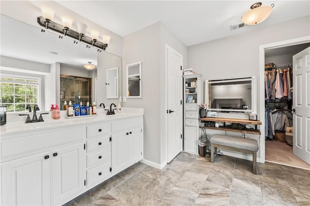 435 Ruby Forest Pkwy, Suwanee, GA 30024 - full bath with double vanity, a walk in closet, a shower stall, and baseboards