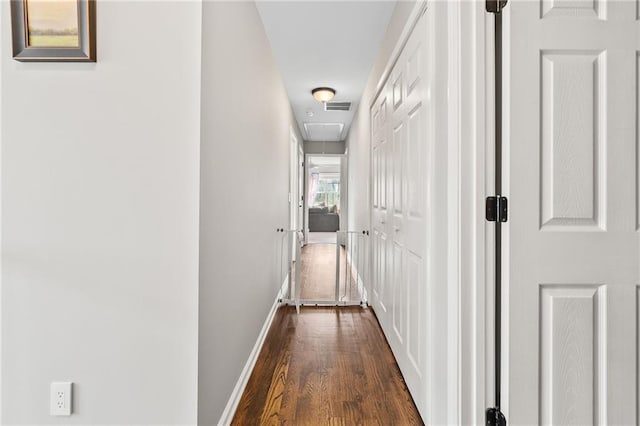 435 Ruby Forest Pkwy, Suwanee, GA 30024 - corridor featuring attic access, dark wood-style flooring, and baseboards
