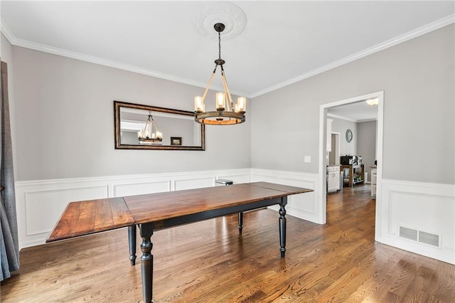 435 Ruby Forest Pkwy, Suwanee, GA 30024 - dining room featuring a chandelier, crown molding, a wainscoted wall, and wood finished floors