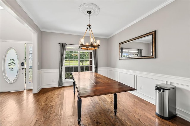435 Ruby Forest Pkwy, Suwanee, GA 30024 - dining space with a chandelier, crown molding, dark wood-style floors, and a wainscoted wall