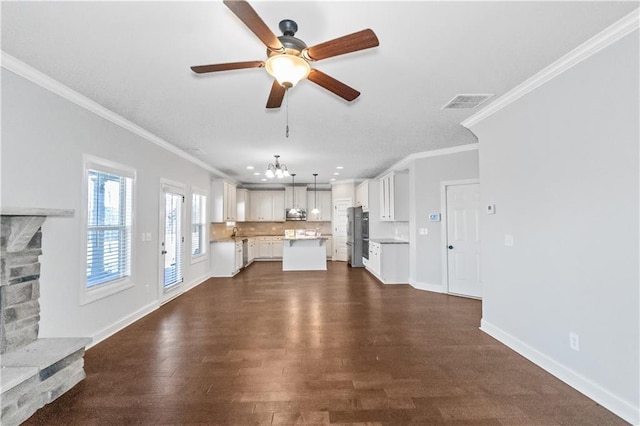 149 Elkins Blvd, Locust Grove, GA 30248 - unfurnished living room featuring crown molding, a fireplace, dark hardwood / wood-style floors, and ceiling fan with notable chandelier