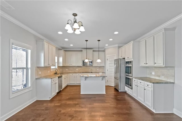 149 Elkins Blvd, Locust Grove, GA 30248 - kitchen featuring pendant lighting, appliances with stainless steel finishes, a kitchen island, and white cabinets