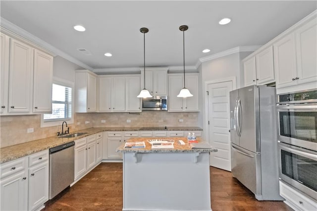 149 Elkins Blvd, Locust Grove, GA 30248 - kitchen with light stone counters, stainless steel appliances, a center island, and sink