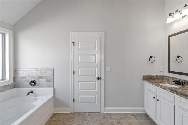 149 Elkins Blvd, Locust Grove, GA 30248 - bathroom featuring vaulted ceiling, a tub, a healthy amount of sunlight, and vanity