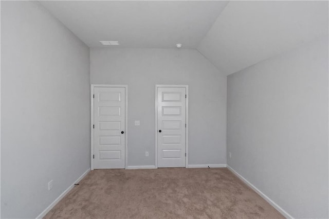 149 Elkins Blvd, Locust Grove, GA 30248 - unfurnished bedroom featuring a closet, vaulted ceiling, and light carpet