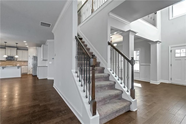 149 Elkins Blvd, Locust Grove, GA 30248 - stairway featuring decorative columns, ornamental molding, and hardwood / wood-style flooring